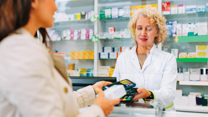Woman buying medicine at a pharmacy