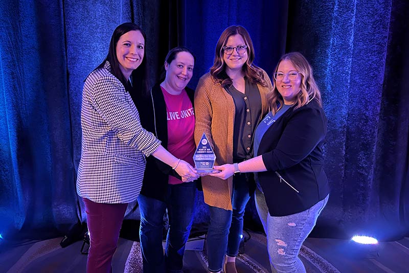 BCBSND employees accepting an award from United Way