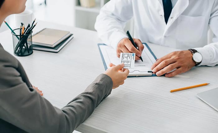 Member showing ID card to provider