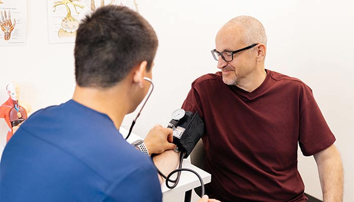 Man getting blood pressure checked in doctor's office