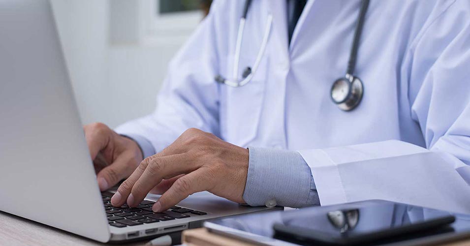 Doctor working on laptop computer