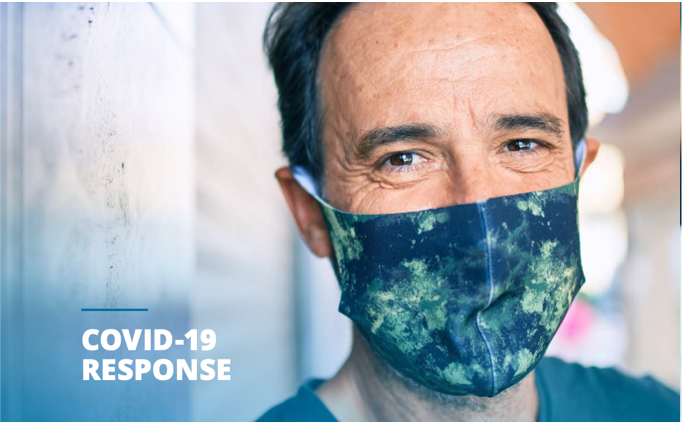 Man wearing a mask on the cover of the BCBSND COVID response summary report.