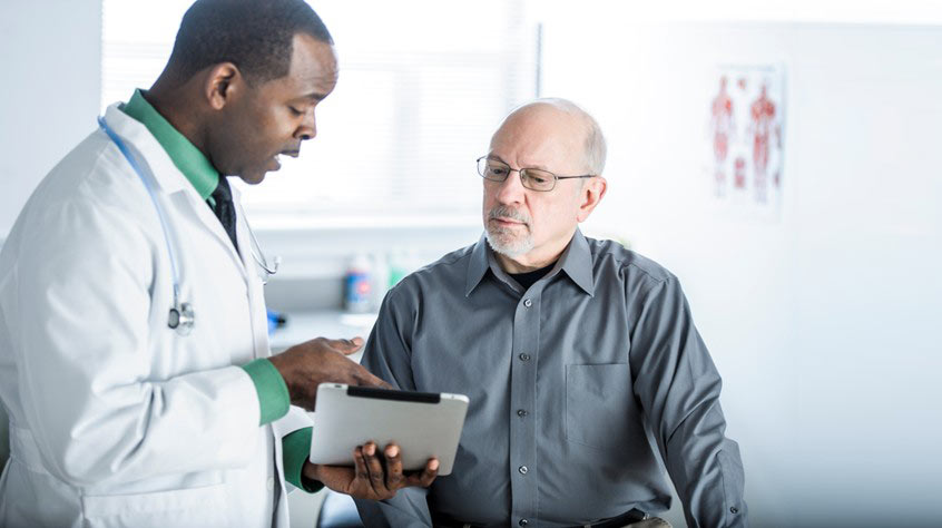 A provider explaining a document to a patient