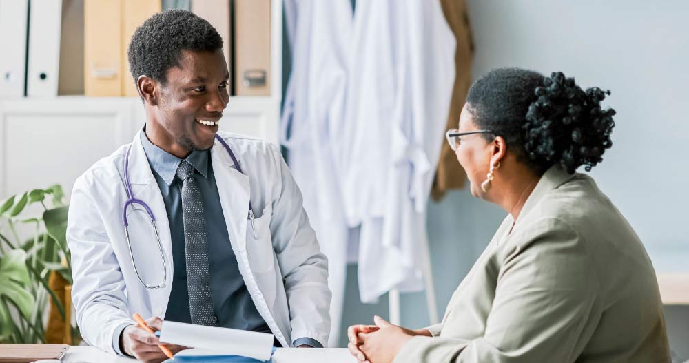 A smiling doctor meeting with a patient