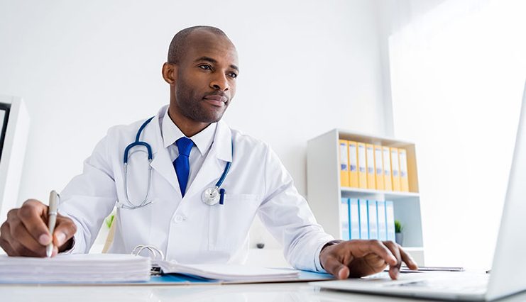 A doctor using a laptop computer
